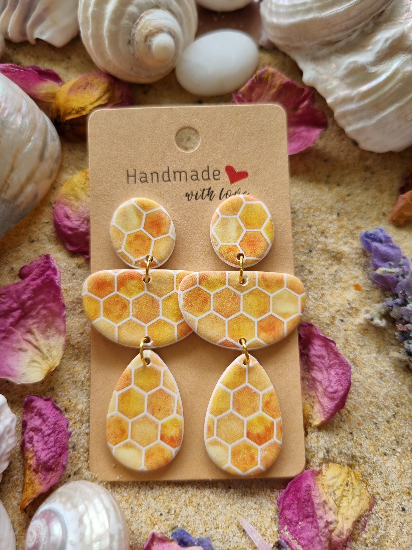 Honeycomb polymer clay dangle earrings in warm yellow and gold with geometric honeycomb pattern, handmade in Australia