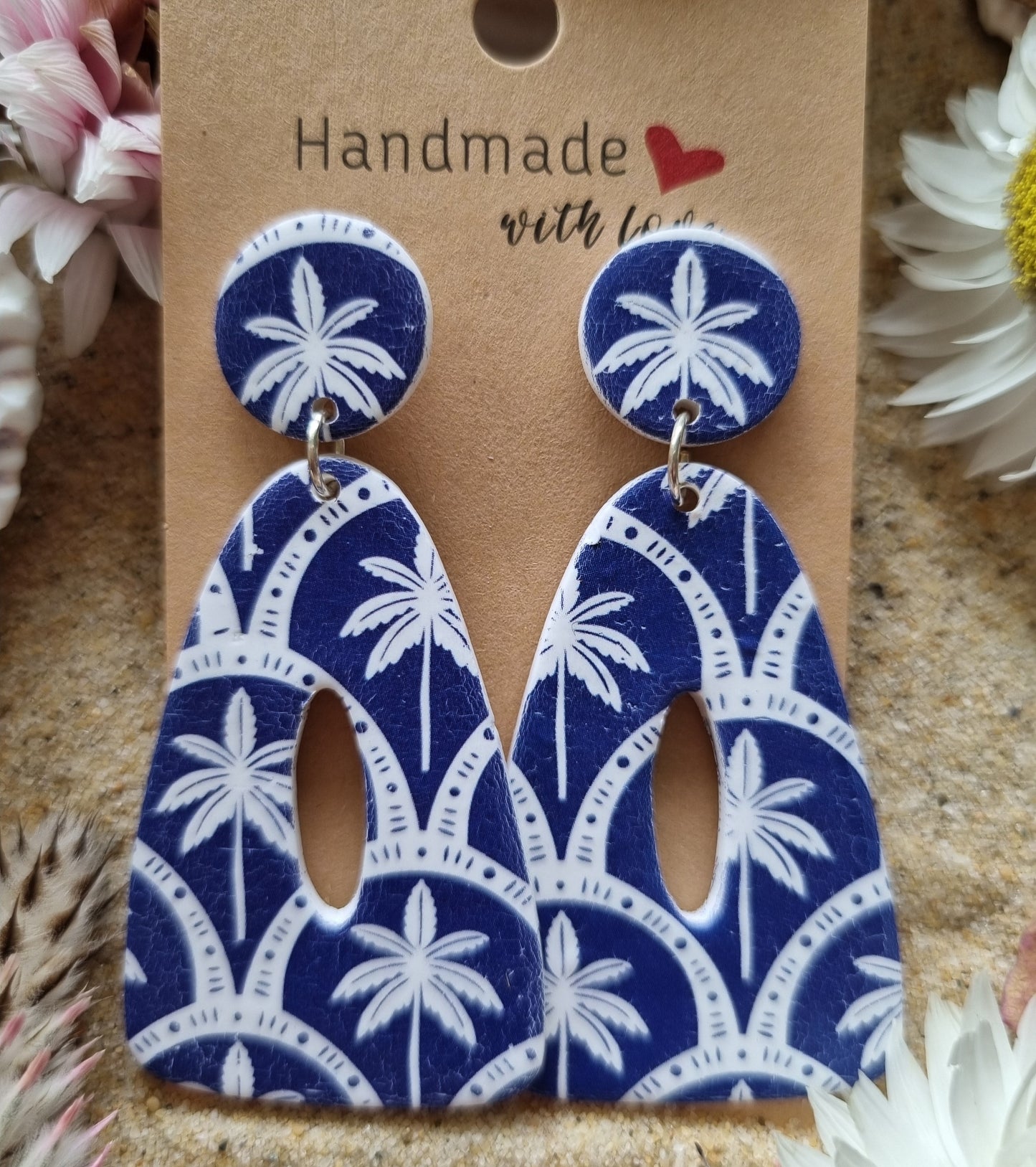 Indigo blue background with white palm tree print dangle earrings, handmade polymer clay earrings by Georgie Who? In Australia