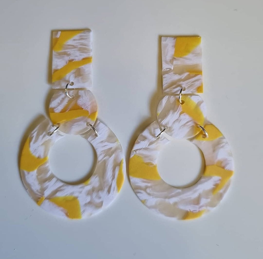 Pair of translucent polymer clay earrings with yellow and white 
