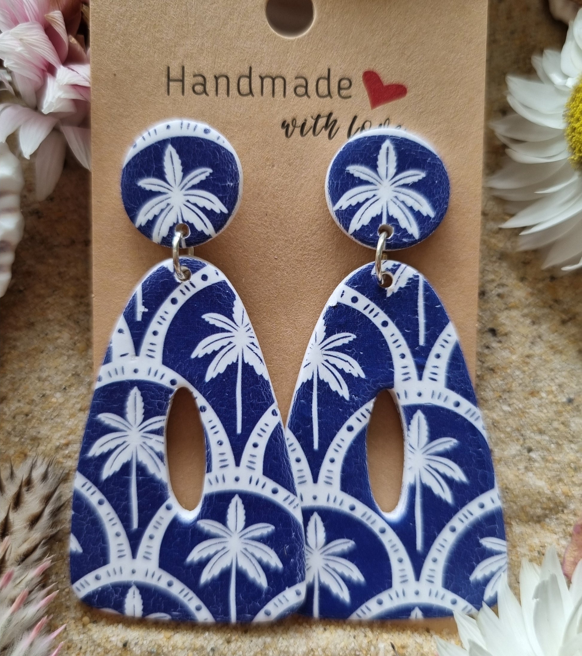 Indigo blue background with white palm tree print dangle earrings, handmade polymer clay earrings by Georgie Who? In Australia 